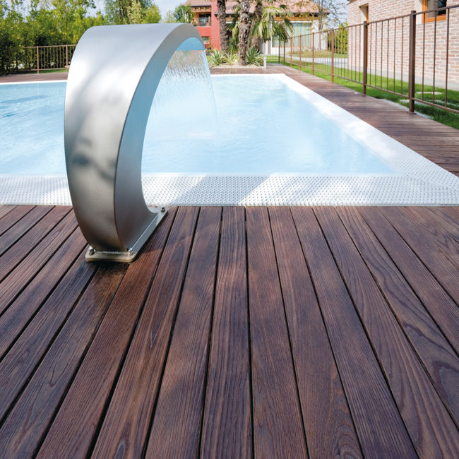 closeup of ash deck surrounding pool with fountain