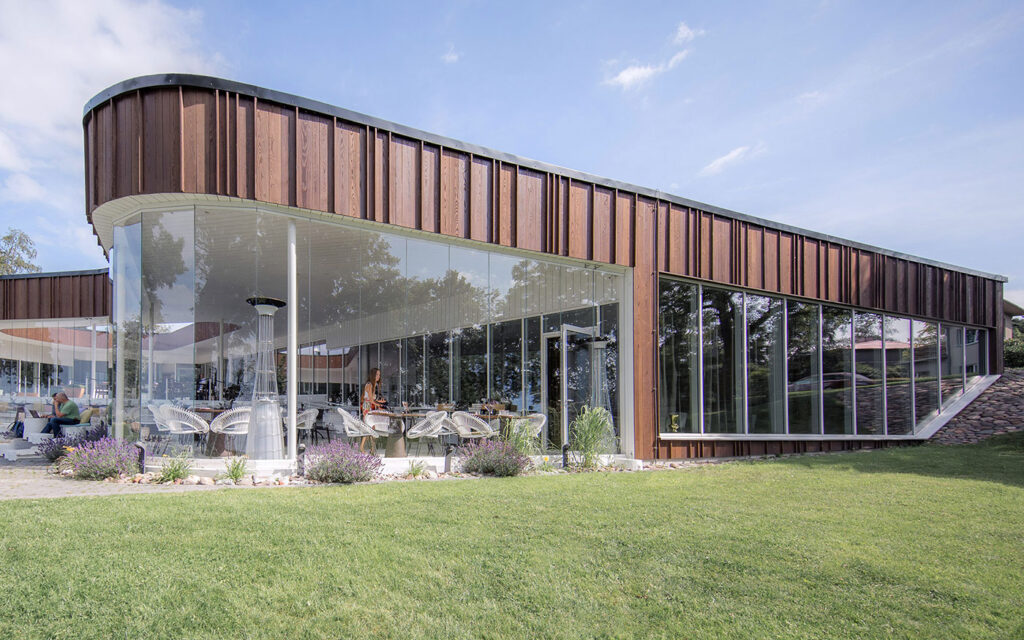 view from outside to inside of restaurant Noa in Estonia.  Clad in Thermory Benchmark Ash