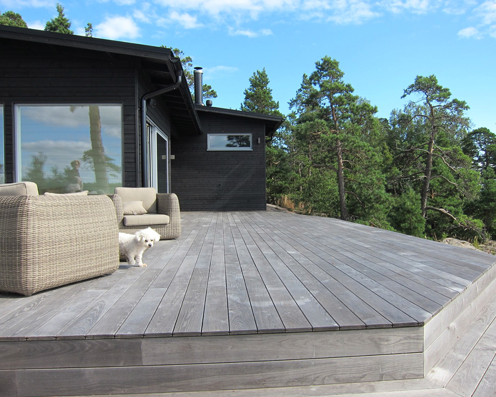 aged benchmark ash deck with dog and patio furniture