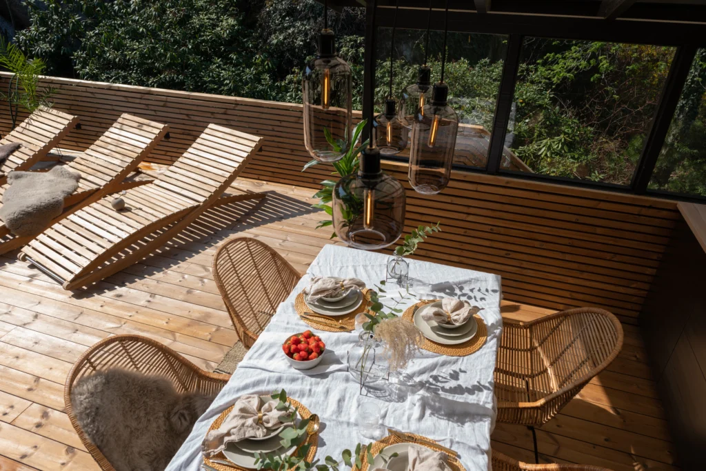 benchmark pine decking and cladding patio dining table lounge area