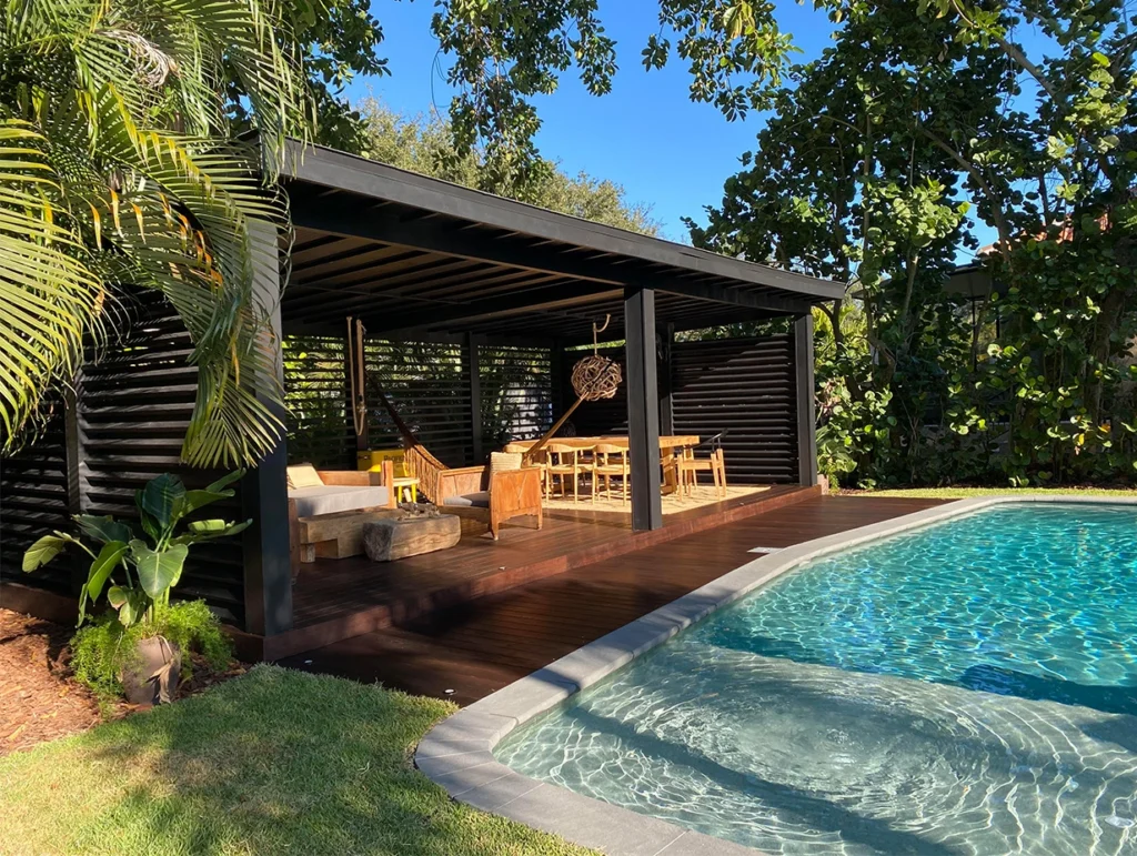 Benchmark Ash by Thermory patio deck by pool finished with Cutek