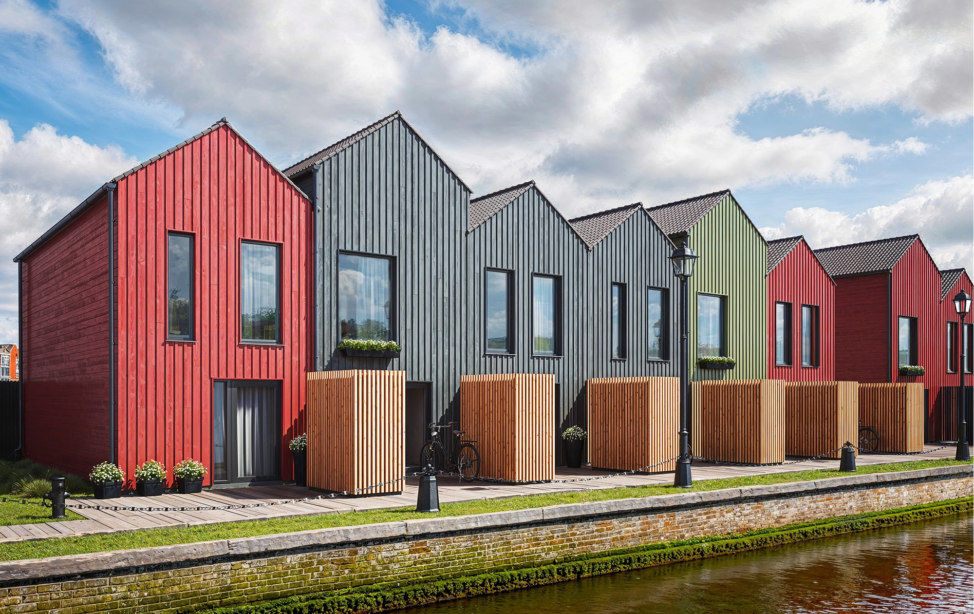 Multi-colored homes with cladding finished Vivid by Thermory