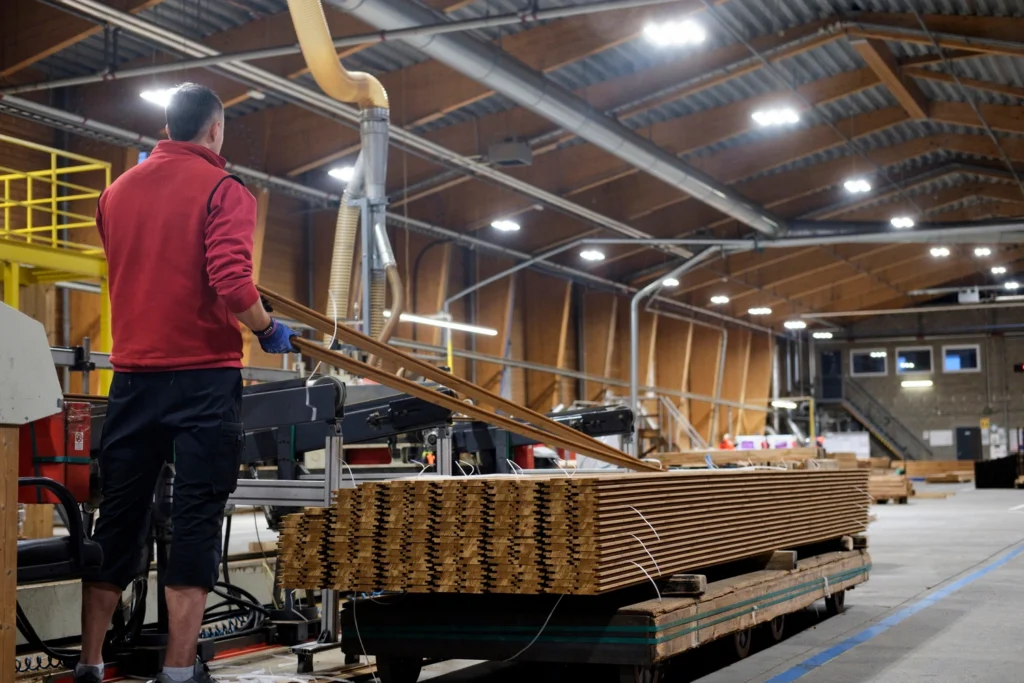 working in Thermory factory stacking boards