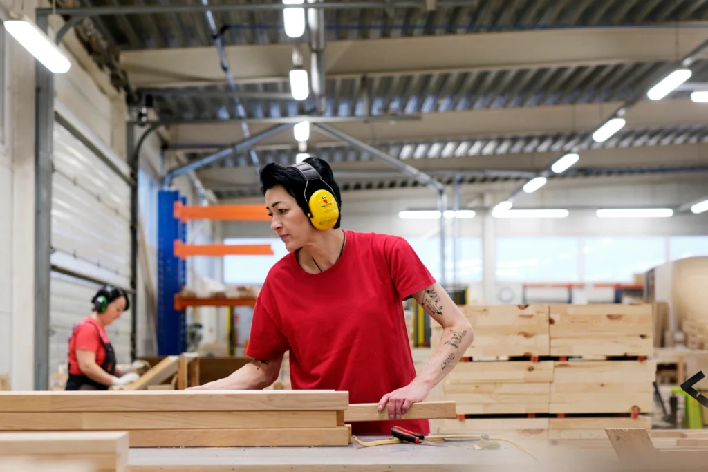 worker in Thermory factory moving boards