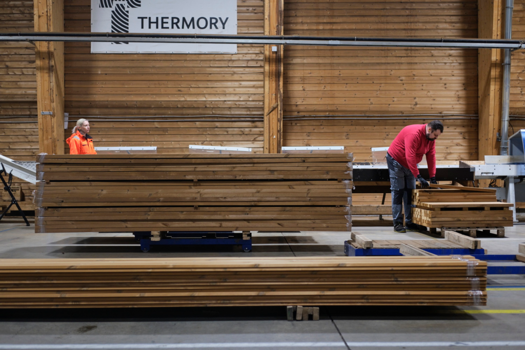 thermory Loo factory workers moving benchmark pine decking