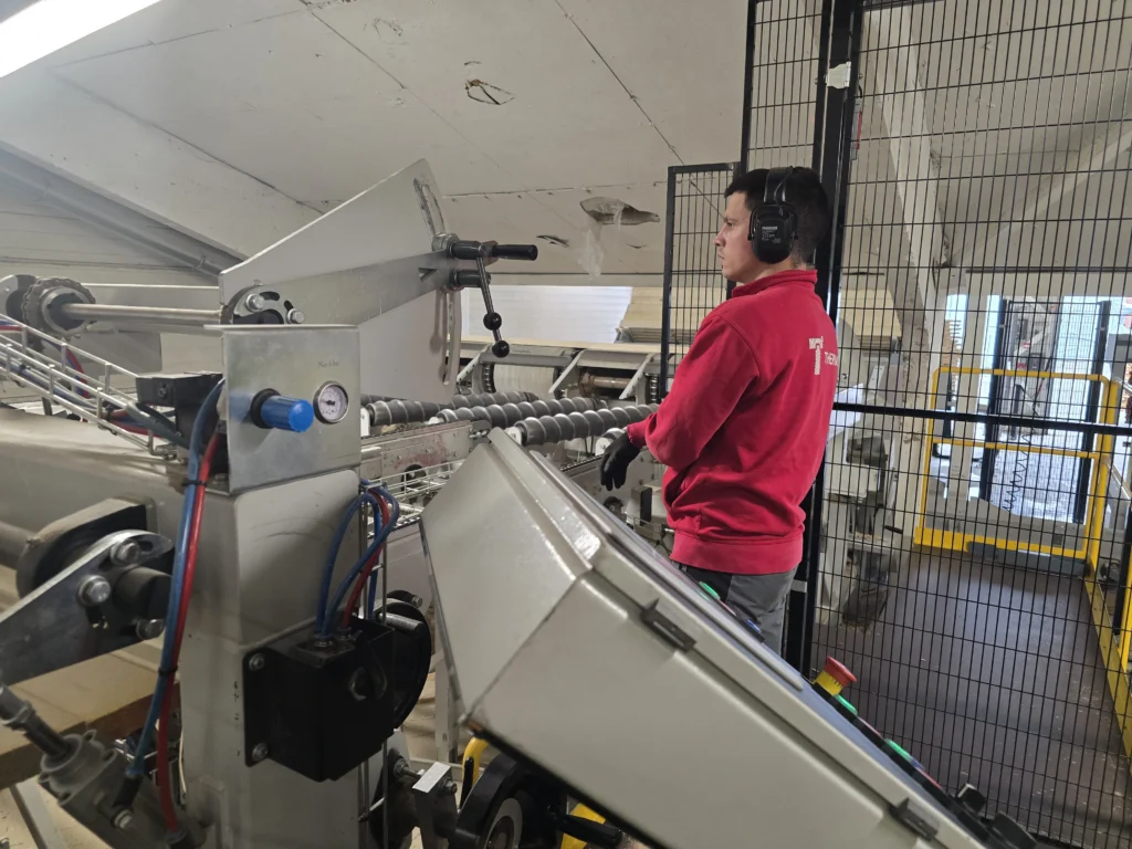 worker operating machine at thermory factory